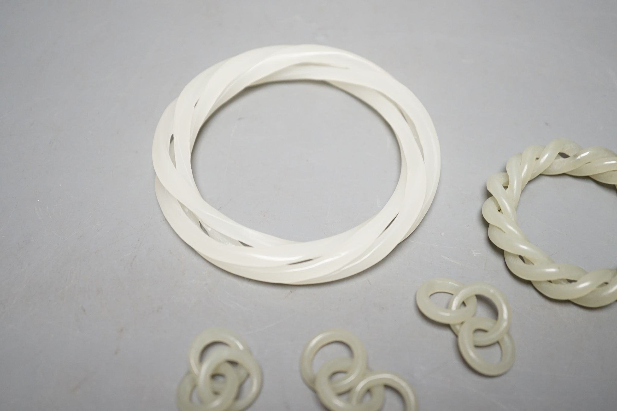 Two Chinese jade corded bangles, and four similar chain sections
